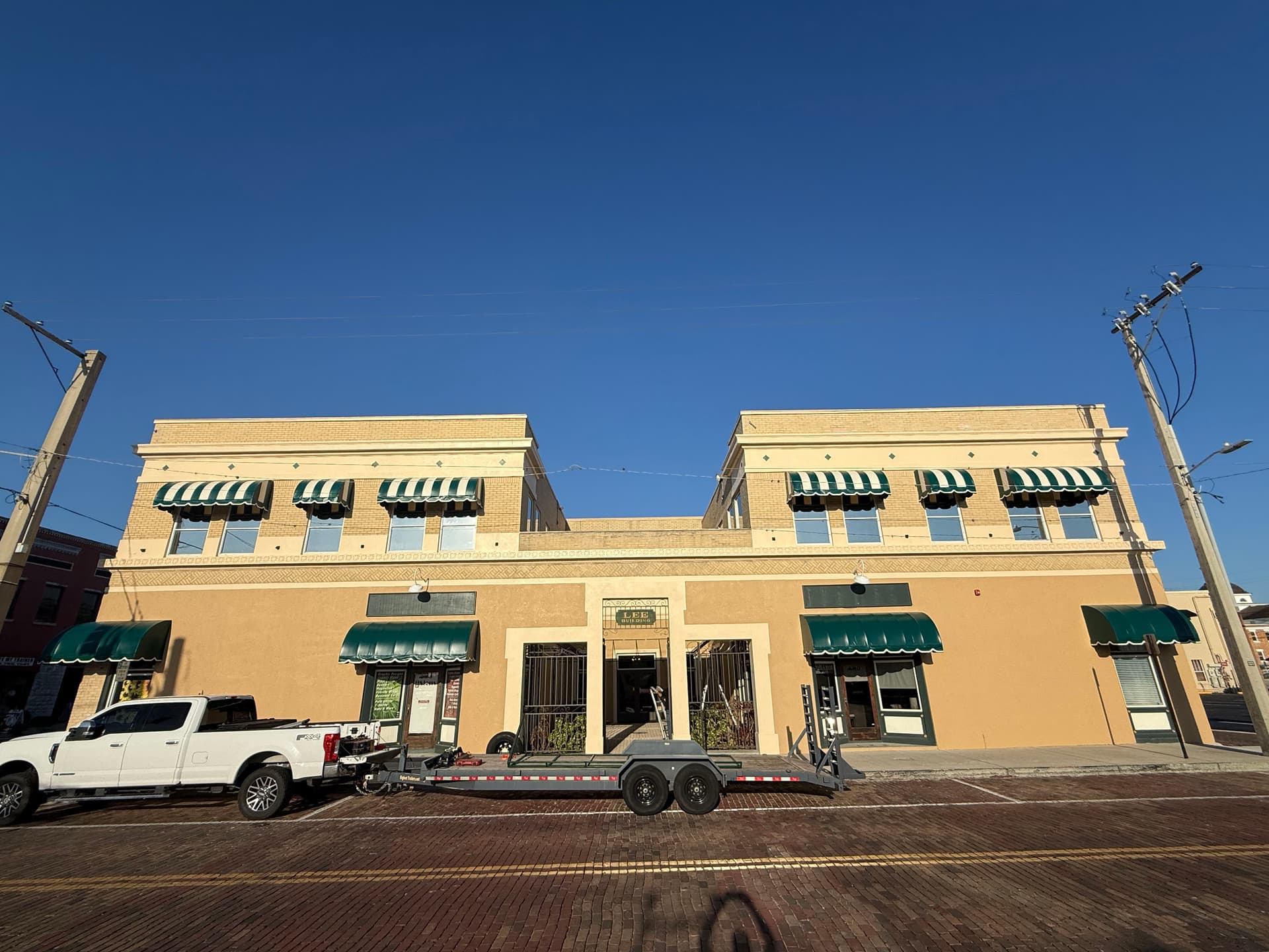 Gallery photos for Green and White Stripe Awning Recover in Downtown Plant City: Image #3