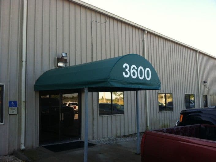 Green awning with "3600" entrance over commercial building exterior.