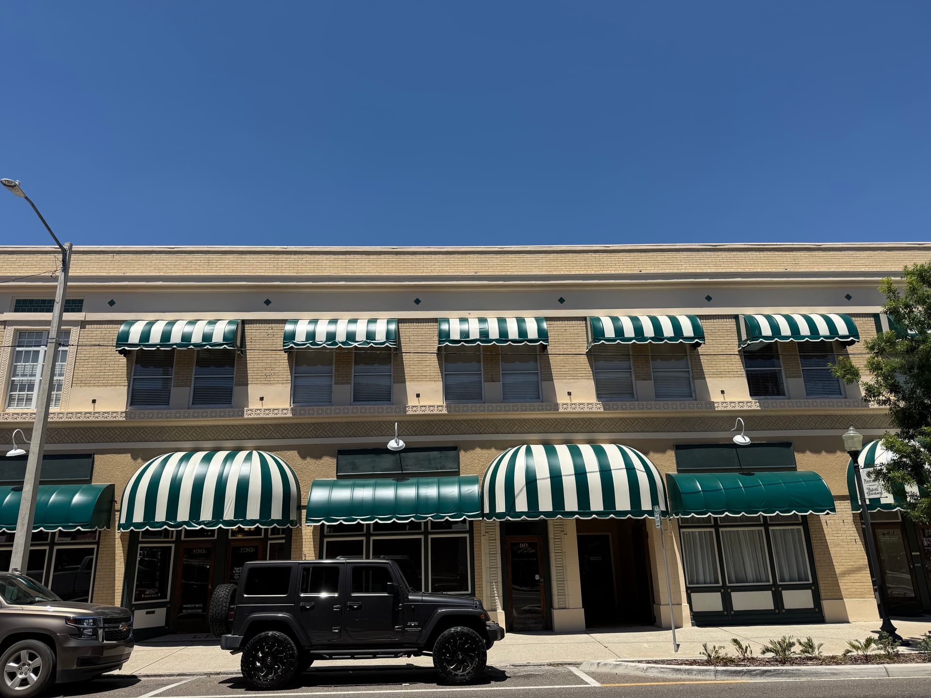Gallery photos for Green and White Stripe Awning Recover in Downtown Plant City: Image #2