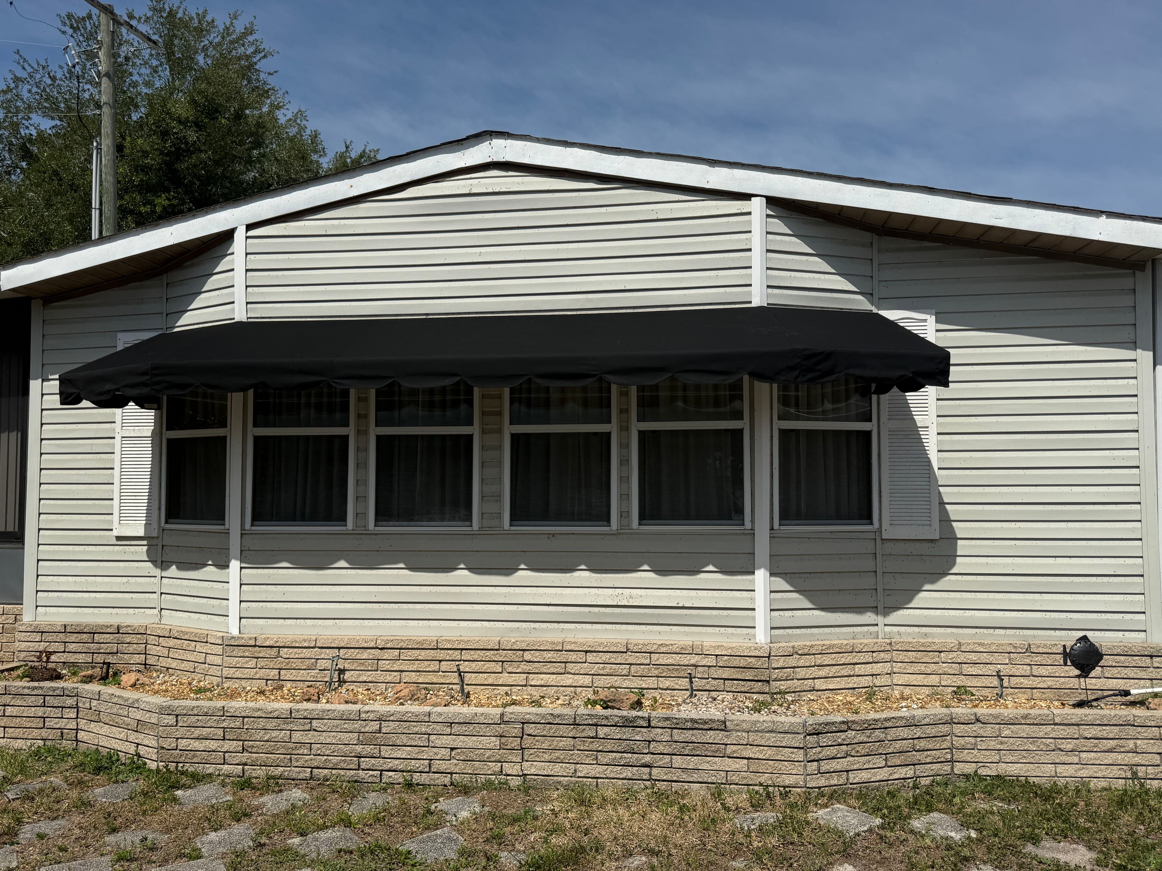 Project Bay Window Awning Recover in Black Sunbrella in Winter Haven image