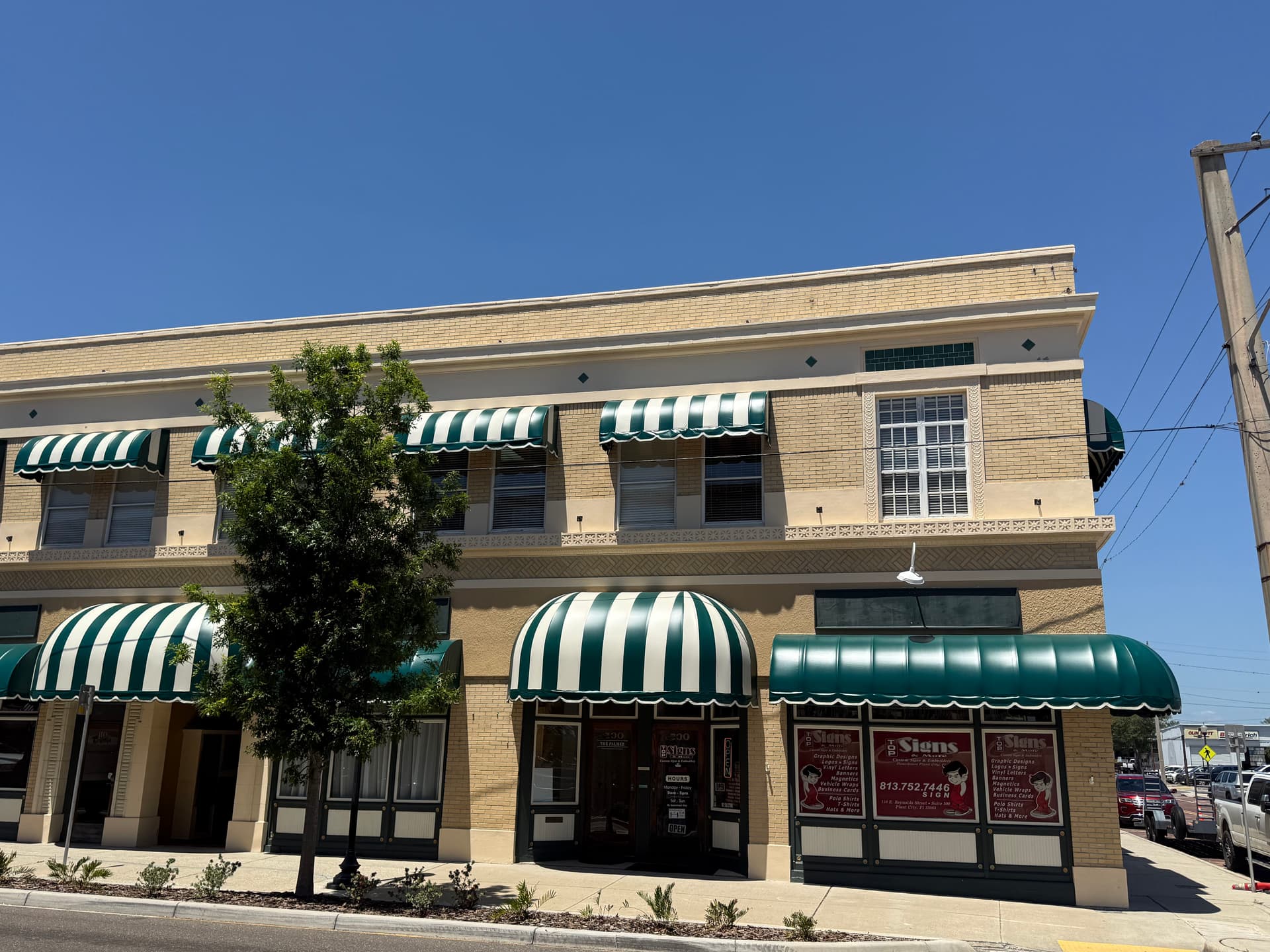 Gallery photos for Green and White Stripe Awning Recover in Downtown Plant City: Image #1